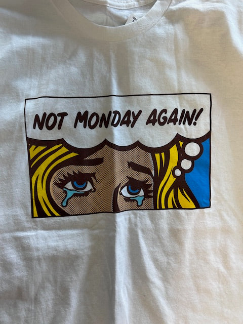 White t-shirt with a colorful graphic design featuring eyes and funny
"not Monday again!" text on a white background
