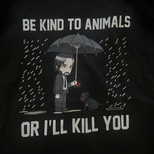 Black t-shirt with graphic design and text 'Be kind to animals or I'll kill you' on a dark background