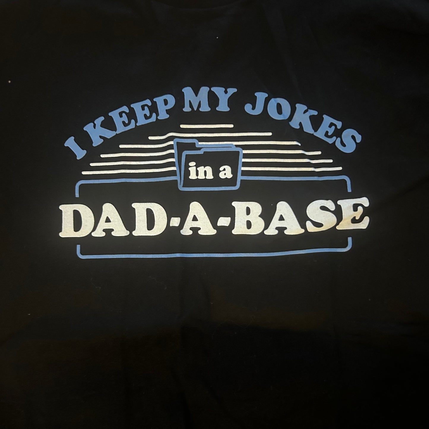 Black t-shirt with a humorous dad joke graphic and text design on a dark background