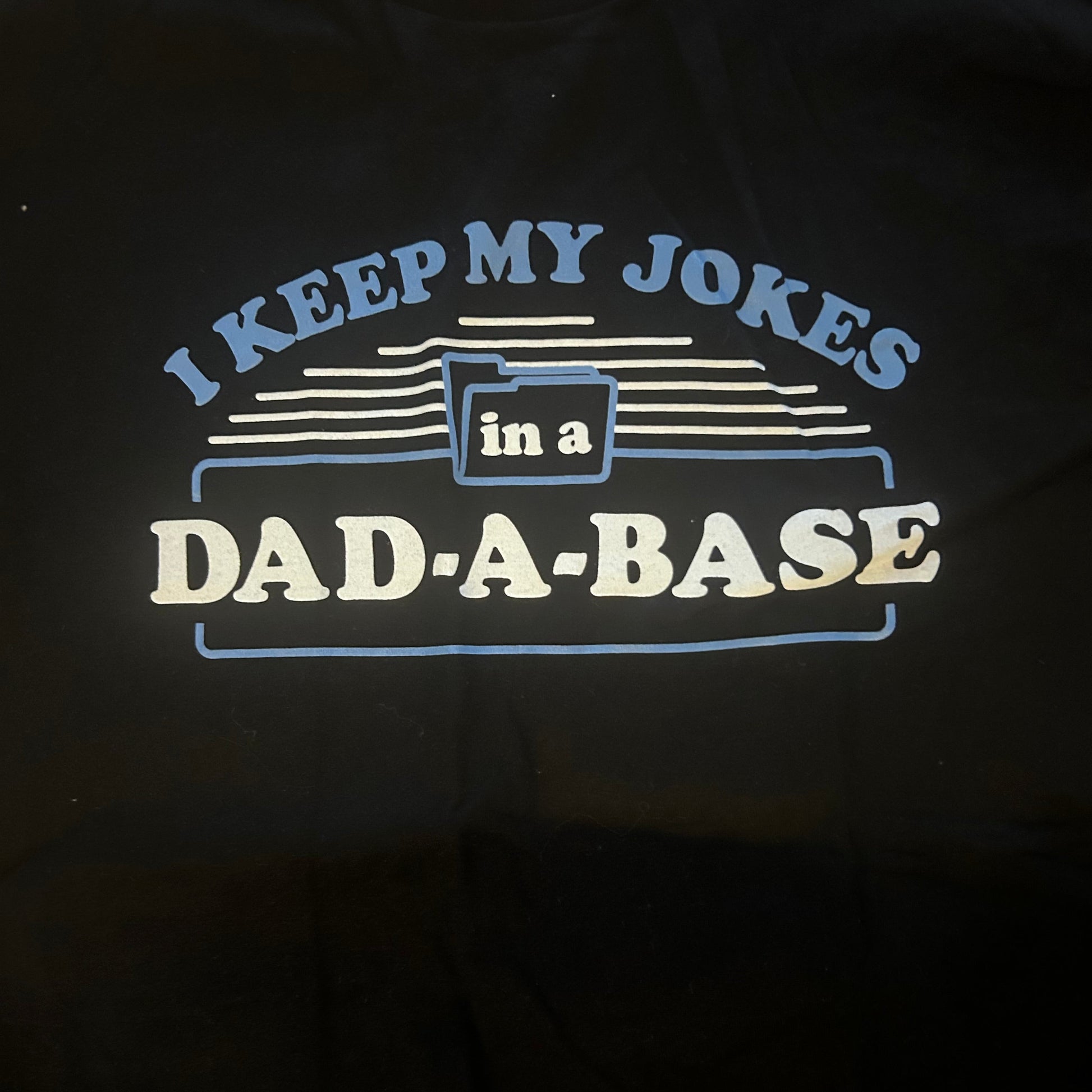 Black t-shirt with a humorous dad joke graphic and text design on a dark background