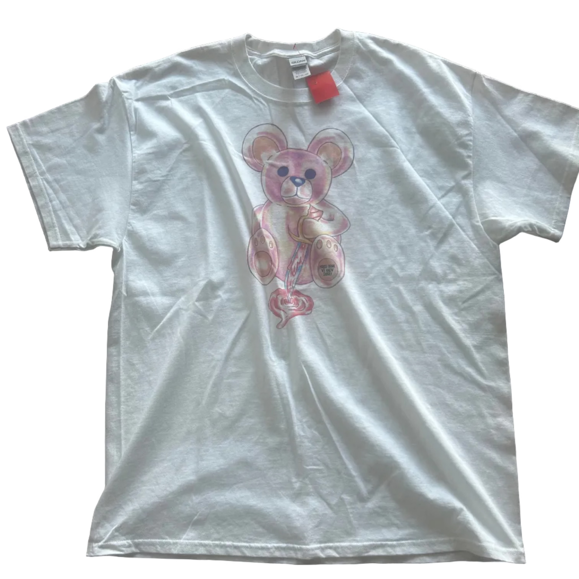 White t-shirt with a crazy pink bear cartoon character on a brown tiled floor