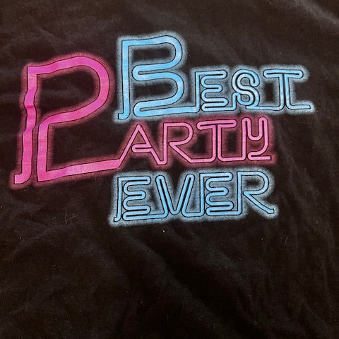 black tee shirt with 'Best Party Ever' text on a dark fabric background