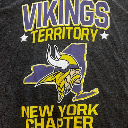 Black t-shirt with Vikings logo and text on a dark background