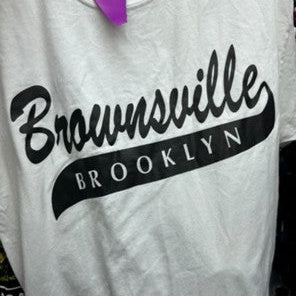 White t-shirt with 'Brownsville Brooklyn' text on a black background