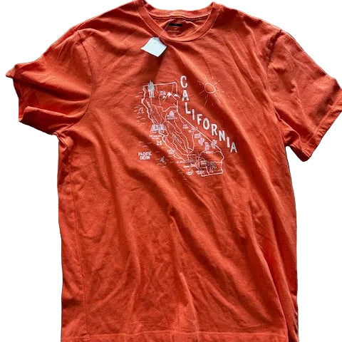 Orange t-shirt with California graphic design on a stone surface