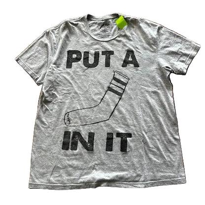 Gray t-shirt with funny "put a sock in it" text and graphic on a tiled floor